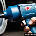 Home 20 에어공구 브랜드 비교 - A high-detail close-up of a professional-grade air impact wrench in action, gripping a heavy-duty bo...